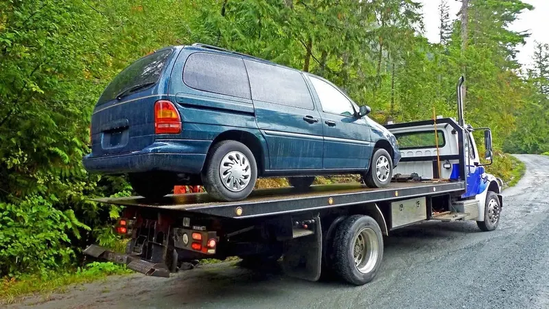 Oakville flatbed towing a cargo van